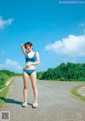 A woman in a white shirt is posing for a magazine.