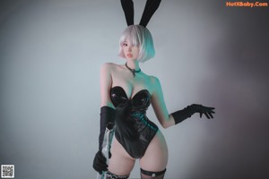 A woman in a bunny costume holding a sword.