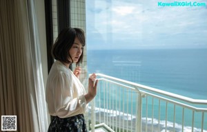 a japanese woman in a white robe is posing for the camera