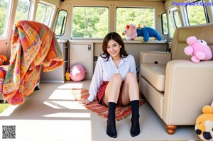 A woman in a white shirt and red plaid skirt posing next to a bike.