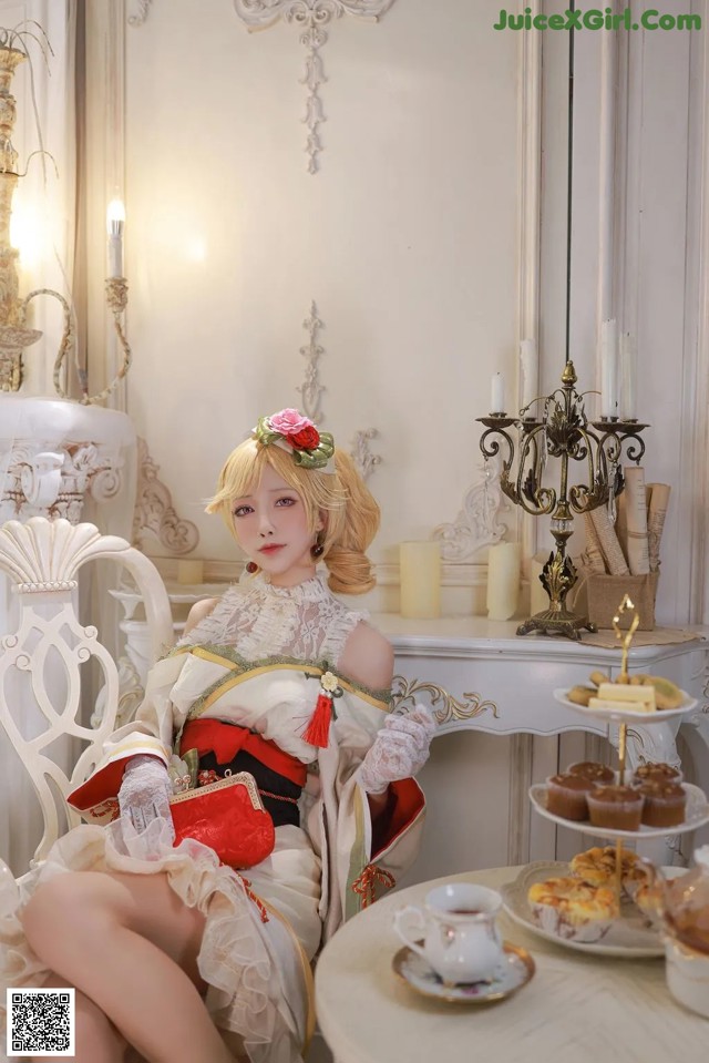 A woman sitting on a white chair in a room.