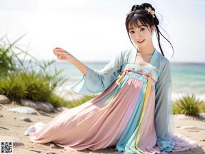 A woman in a blue and white hanbok standing in a garden.