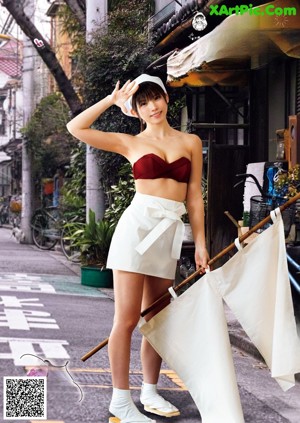 A woman in a black and white outfit is posing for a picture.