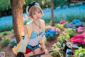 A woman in a costume holding a sword in a garden.