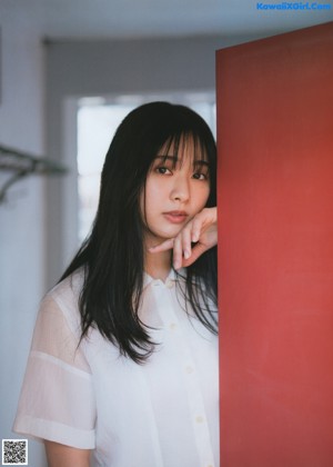 A woman with long black hair is posing for a picture.