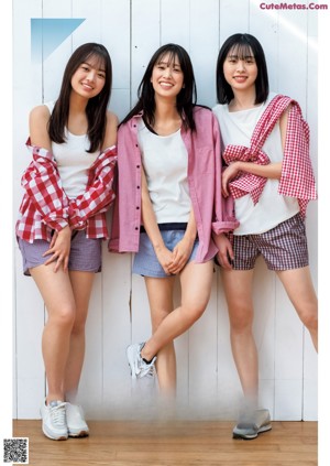 A group of three young women posing for a picture.