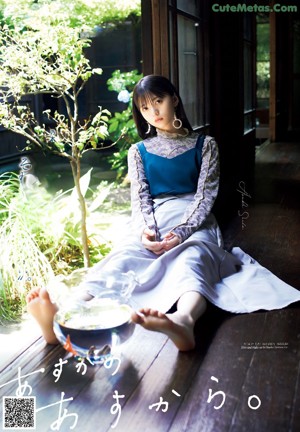 A woman laying on top of a bed covered in yarn.