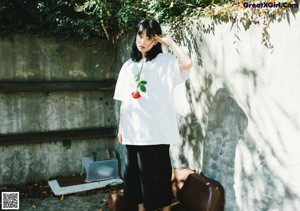 A woman in a red kimono sitting on the floor.