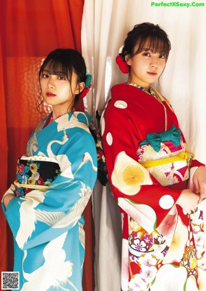 A woman in a kimono sitting on a chair.