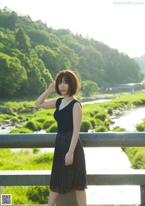 A woman in a black top is posing for a picture.