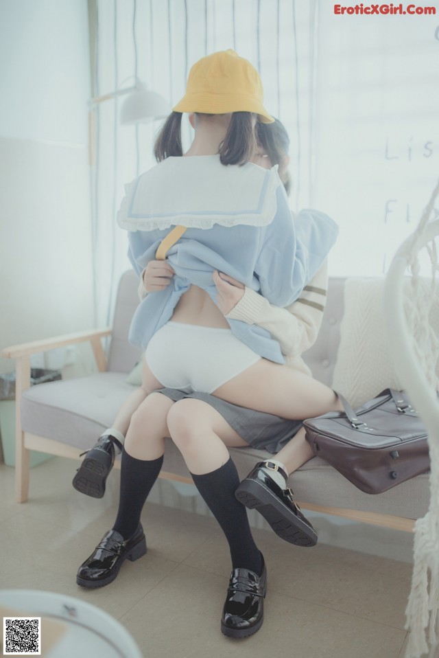 A couple of women sitting on top of a couch.