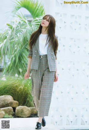 a japanese woman with long brown hair and a white shirt